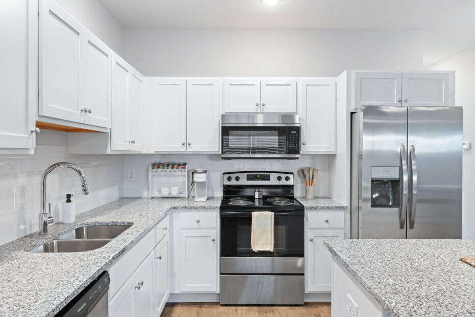 Open-concept kitchen with stainless steel appliances and granite countertops