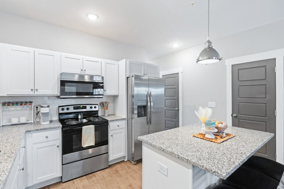 Open-concept kitchen with stainless steel appliances and granite countertops