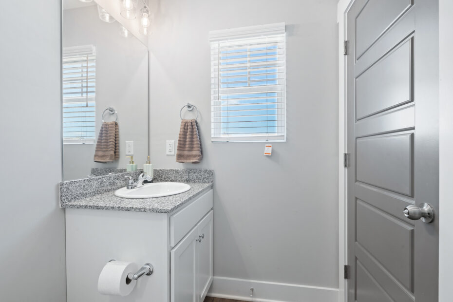 Private bathroom featuring a bathtub and granite countertops at The Haven at Wake.